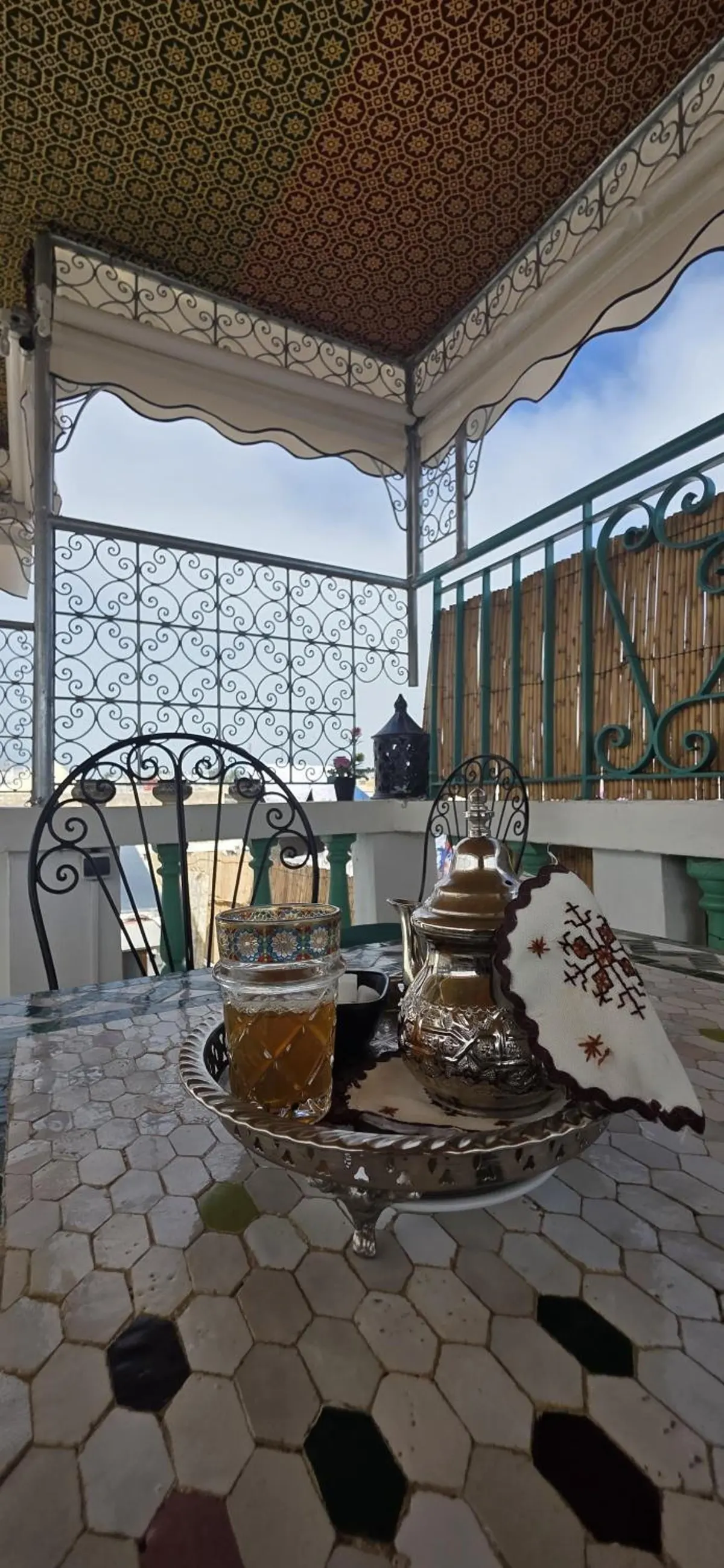 Silver teapot and tea glasses on the terrace