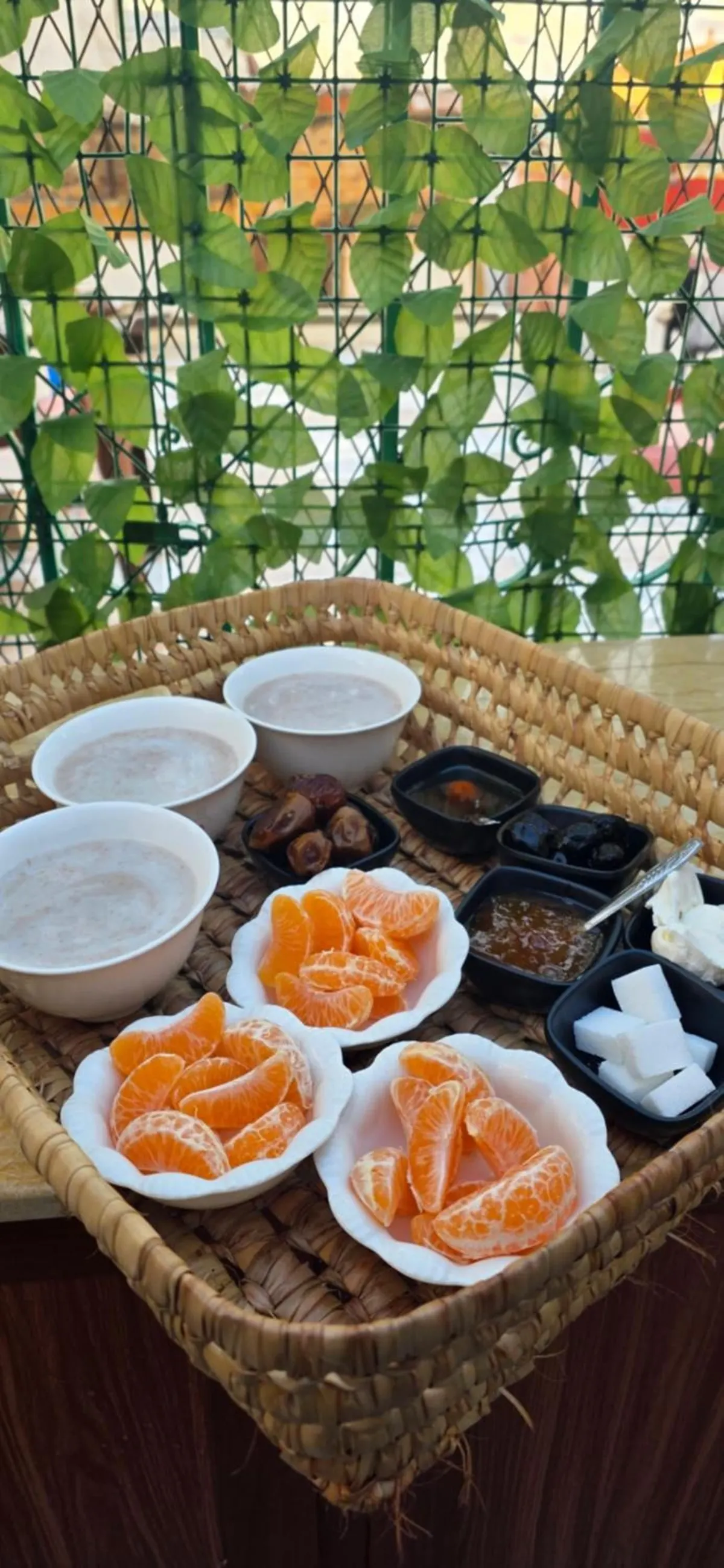 Tray of mandarins, dates, spreads and bowls