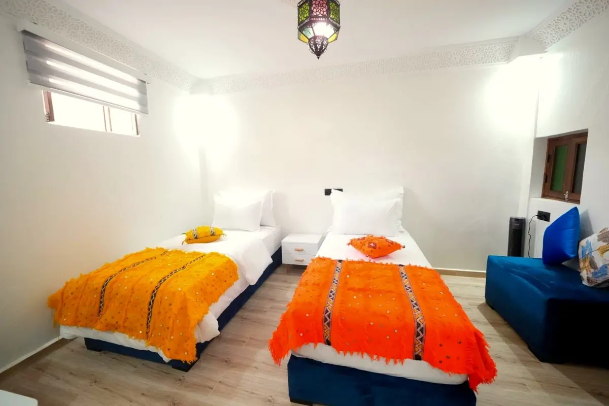 Orange and saffron blankets, a cobalt sofa and a hanging lantern